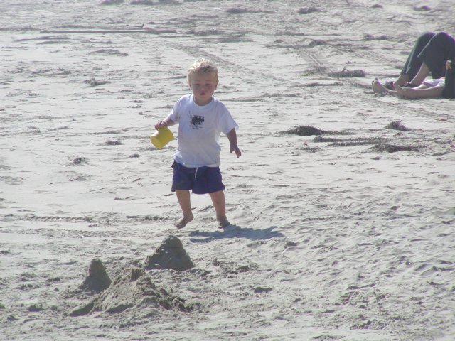 Timothy investigates a sand castle