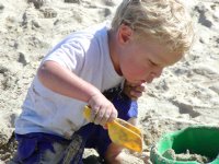 Timothy plays with sand toys