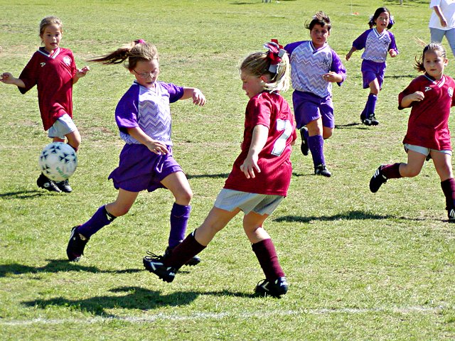 A butterfly kicks the ball past Natalie