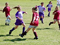 A butterfly kicks the ball past Natalie