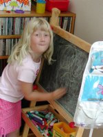 Sara drawing at her easel