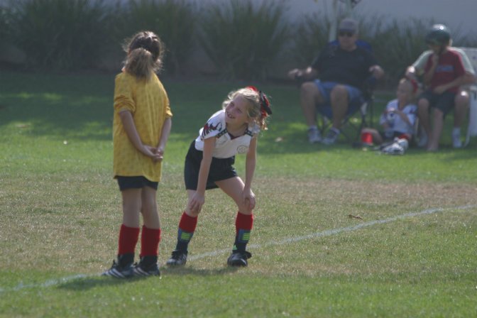 Two Fire Eagles chat in the backfield
