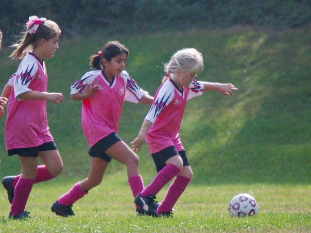 Sara leads Evangeline and Maryam along the far sideline