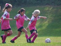 Sara leads Evangeline and Maryam along the far sideline