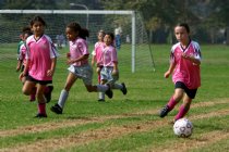 Frankie takes it up the sideline as Maryam watches