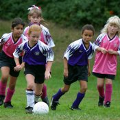 Maryam, Evangeline, and Sara trail two puppies