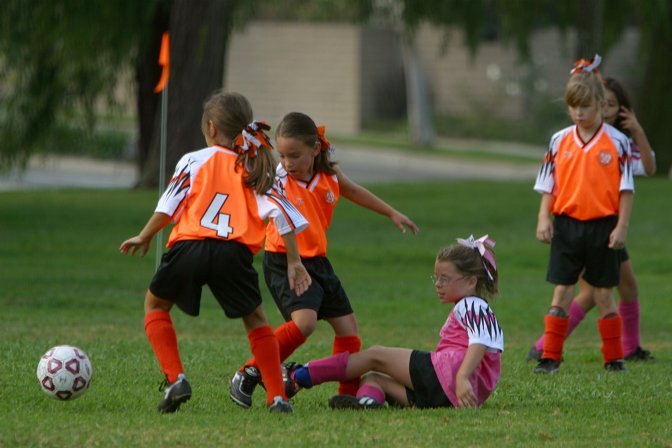 Natalie falls while two Tigers take the ball