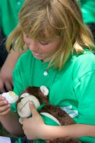 Jennifer shares her snack with the player-of-the-game monkey