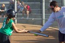 Joel helps Kelsey tune up her swing before batting