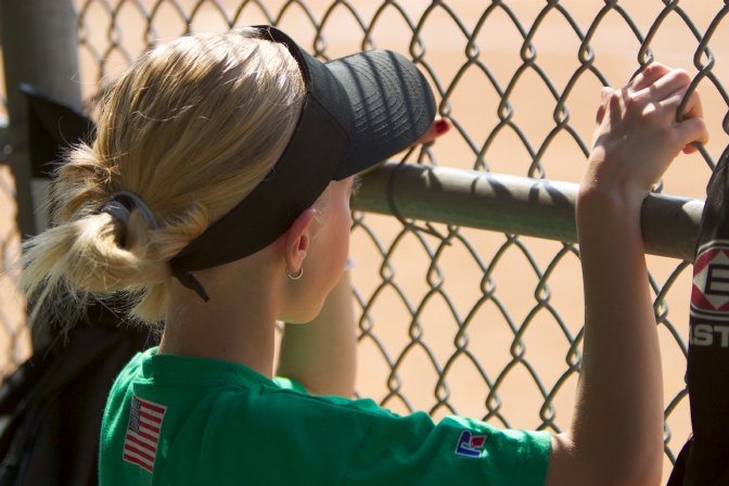 Lindsey watches the game from the dugout