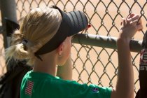 Lindsey watches the game from the dugout
