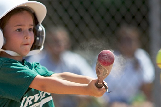 Dust flies from Darya's bat
