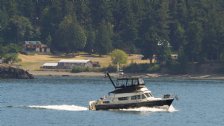 Another boat cruises past the airstrip on nearby Blakely Island