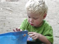 Timothy plays with the tent