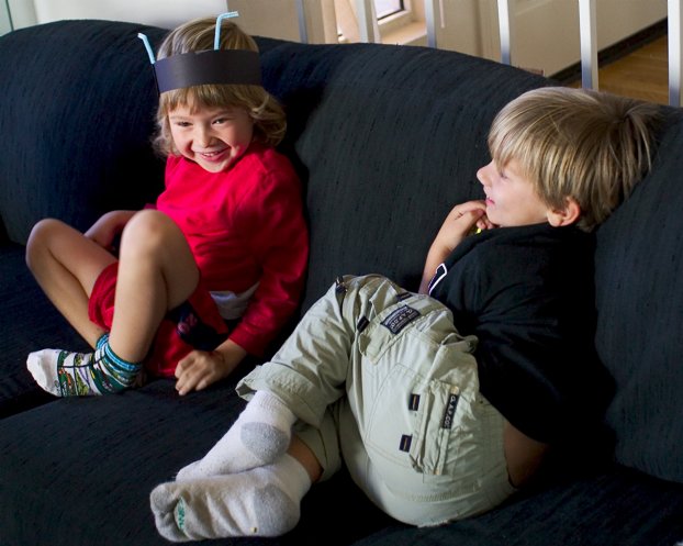 Nico and Casey play tag in the living room