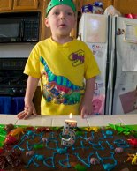 Timothy gets ready to blow out the birthday candle