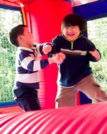 Hanlin and Ken roughhouse in the bouncer