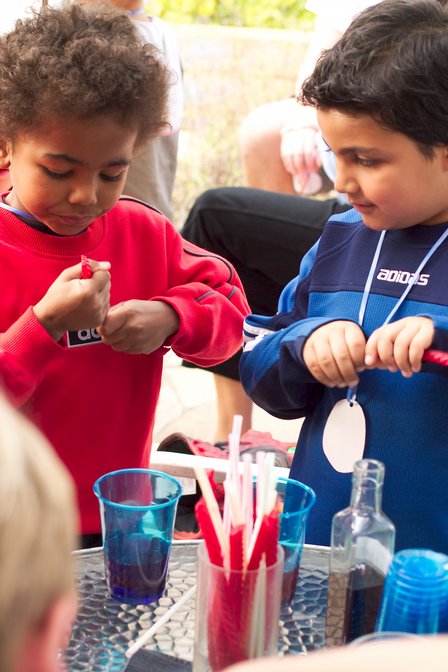 Tayo and Eliya with red vine potion stirrers