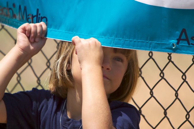 Alana plays behind the Mariner banner