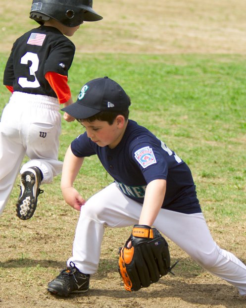 A Giant base runner gets around Noah as he goes for a low throw