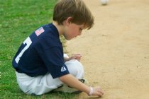 Max plays in the sand behind the backstop