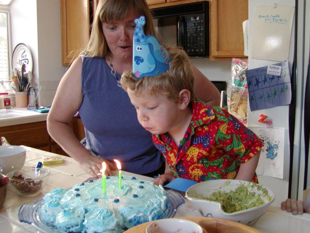 Timothy blows out the candles