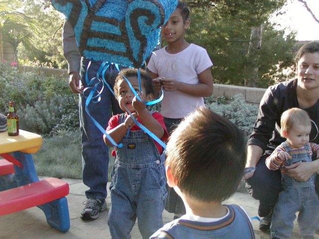 Miles pulls at the piñata