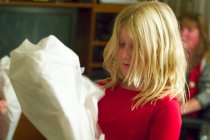 Sara unwraps a dragon kite