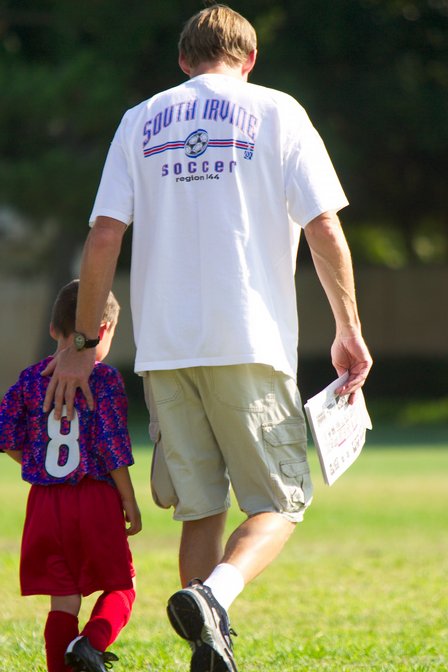 An injured Spiderman walks off the field