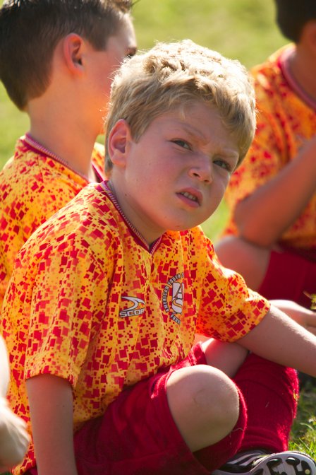 Timothy sits on the field at halftime